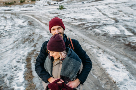 Happy loving couple walking in snowy winter, Vacation together. Young hipster couple. Winter love story, a beautiful stylish young couple.の写真素材