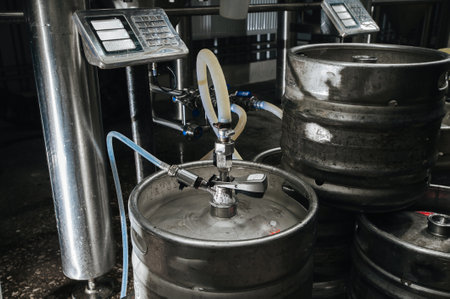 Steel industrial stack of beer kegs against. Modern brewery and equipment machinery tools for alcohol production.の写真素材