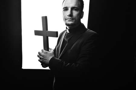 Priest man wearing catholic robe with cross. Religion person.の写真素材