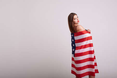 Beautiful sport woman holding american flag and smilingの写真素材