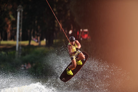KHARKIV, UKRAINE - July 31, 2021: Championship of Ukraine. Wakeboarder showing of tricks and skills at wakeboarding event in Kharkiv.のeditorial素材