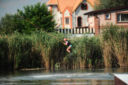 KHARKIV, UKRAINE - July 31, 2021: Championship of Ukraine. Wakeboarder showing of tricks and skills at wakeboarding event in Kharkiv.のeditorial素材