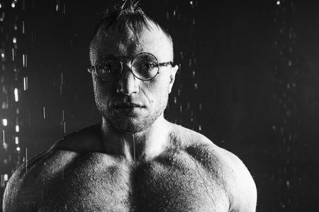 Handsome muscular man in shower. Portrait. Individuality.