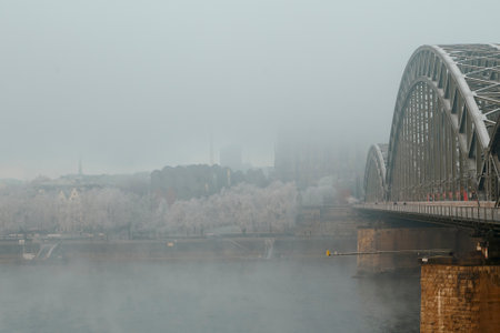 Cologne, Germany - December 16, 2022: Frozen and fog. The Hohenzollern bridge over Rhine river.のeditorial素材