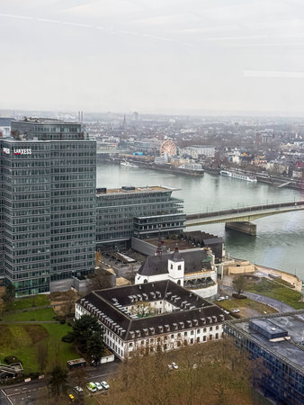 COLOGNE, GERMANY - 01 January, 2026: Cologne-Deutz skyline with the LANXESS Tower, Deutzer BrÃ¼cke and the Rhine; Ferris wheel glowing on the Old Town riverside under low winter clouds.のeditorial素材