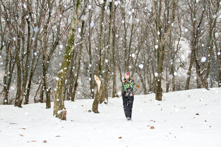 Beautiful and sexy  woman in ski suit ran  in snowy winter outdoors. more photos from this series in my portfolio!の写真素材