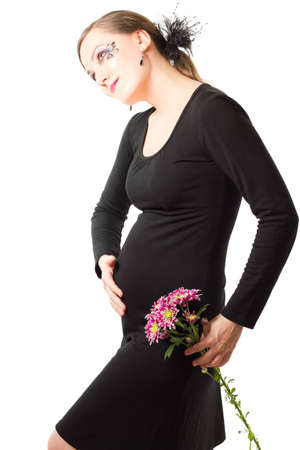 young pregnant woman  with body art butterfly on face with  flower chrysanthemum on a white backgroundの写真素材