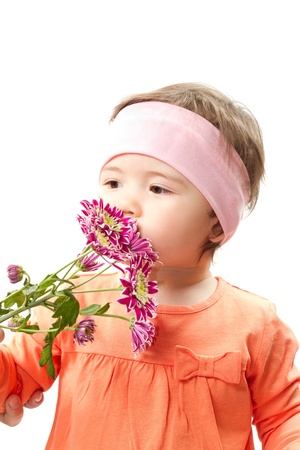 Cute little baby girl with flowers for mother on white background の写真素材