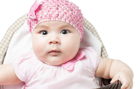 beautiful girl baby in a basket on a white background isolated