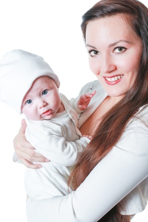 Happy mom and baby girl hugging on isolated white backgroundの写真素材