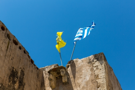 National flag on the roof of Monastery (friary) in Messara Valley at Crete island in Greece.の写真素材