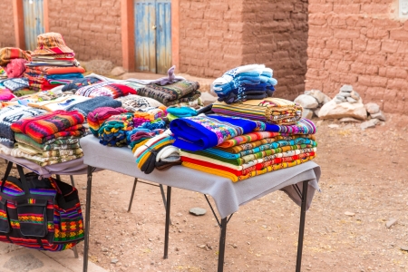 Souvenir market near towers in Sillustani, Peru,South America. Street shop with colorful blanket, scarf, cloth, ponchos,ornaments,の写真素材