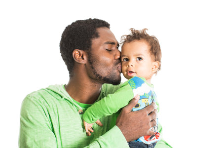 Happy black father and  baby boy cuddling on isolated white Use it for a child, parenting or love conceptの写真素材