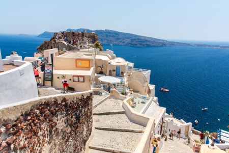 View of Fira town - Santorini island,Crete,Greece  White concrete staircases leading down to beautiful bay with clear blue sky and seaのeditorial素材