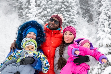 Happy Family with children in ski suit in snowy winter outdoors, Almaty, Kazakhstanの写真素材
