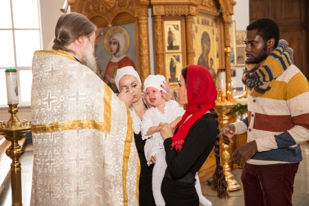 ALMATY, KAZAKHSTAN - DECEMBER 17: Christening ceremony on December 17, 2013 in Almaty, Kazakhstan. Family celebrating  baptism in Orthodox Church - Monastery of St. Matronaのeditorial素材