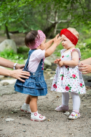 Two year-old adorable child girls playing on nature summerの写真素材