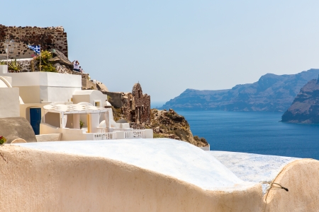 View of Fira town - Santorini island,Crete,Greece. White concrete staircases leading down to beautiful bay with clear blue sky and seaのeditorial素材