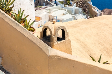View of Fira town - Santorini island,Crete,Greece. White concrete staircases leading down to beautiful bay with clear blue sky and seaの写真素材
