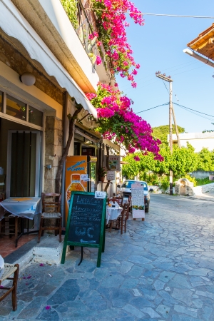 Branches of flowers pink bougainvillea bush on Balcony in street, Crete, Greeceのeditorial素材