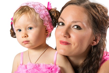 Happy mom and child girl hugging and laughing isolate on white background. The concept of cheerful childhood and family. Beautiful Mother and her babyの写真素材