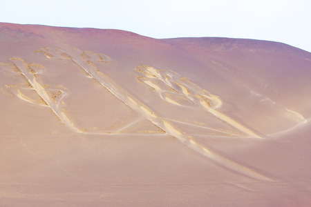 Candelabra, Peru, ancient mysterious drawing in the desert sand, Paracas National Parkの写真素材