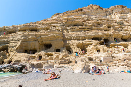 Pebbly beach Matala, Greece Crete. Matala has become famous for artificial  Neolithic caves, carved...