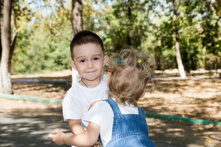 Baby boy and adorable child girl in park. Summer green nature . The concept of childhood and loveの写真素材