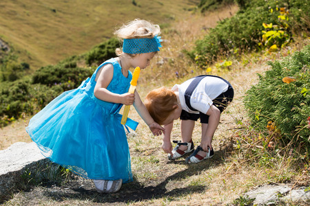 Baby boy and adorable child girl on grass. Summer green nature . The concept of childhood and loveの写真素材