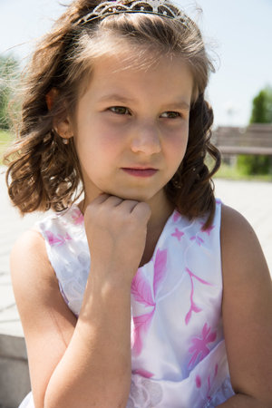 Adorable child girl with flower. Summer green nature .  Use it for baby, parenting or love concept