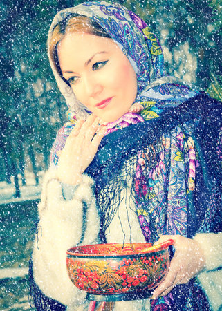 Portrait of young caucasian woman in traditional russian pavloposadskie  folk scarf on head. Russian...