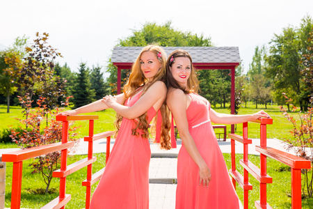 Two young beautiful woman with long hair and outdoorの写真素材
