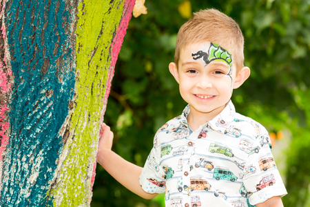 Cute little child boy with akvagrim in park on nature at summer. Use it for baby, parenting or love conceの写真素材