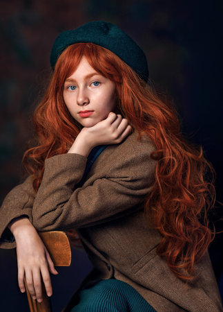 Red-haired girl with long wavy hair posing in vintage clothing. Cinematic and emotional portrait...