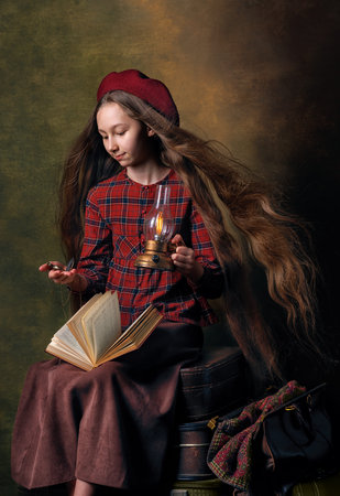 Vintage-style girl in red plaid dress sitting on colorful retro suitcases with travel mood, travel-inspired atmosphereの写真素材