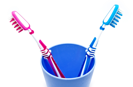 two toothbrushes in glass isolated on white backgroundの写真素材