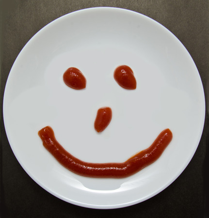A smiling plate on a dark backgroundの写真素材