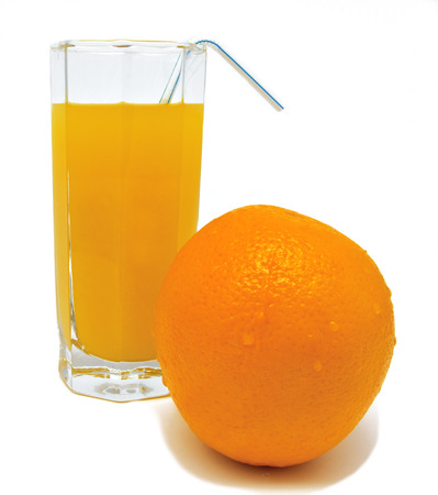 Glass of orange juice with yellow orange and tubule isolated on white backgroundの写真素材