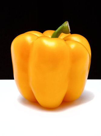 Yellow bell pepper on a black and white