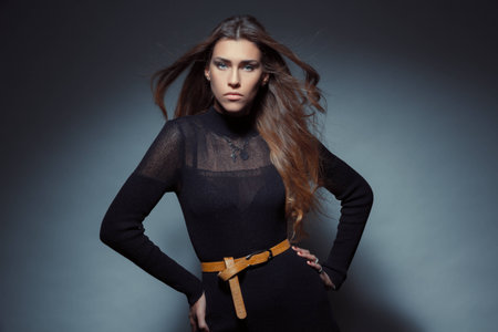 Glamour women look to camera in studio on dark backgroundの写真素材