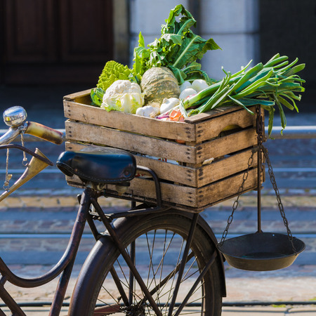 wooden box with fruits and vegetables on vintage bicycleの写真素材