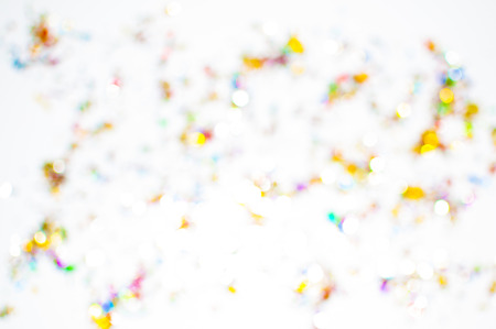 Confetti scattered in all colors with white background unfocusedの写真素材