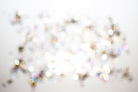 Confetti scattered in all colors with white background unfocusedの写真素材