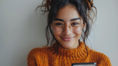 Woman with glasses holding a cell phone.の素材