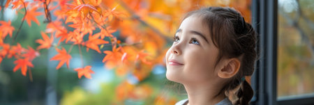 A young girl standing by a window, gazing outside.の素材