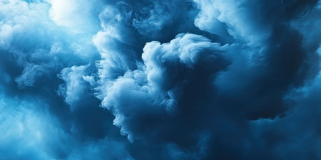 Dramatic blue clouds swirl together, creating captivating shapes in the evening sky.の素材