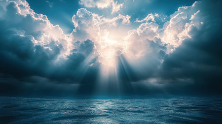 Sunlight breaks through dramatic clouds over a calm ocean, creating a serene and beautiful atmosphere.の素材