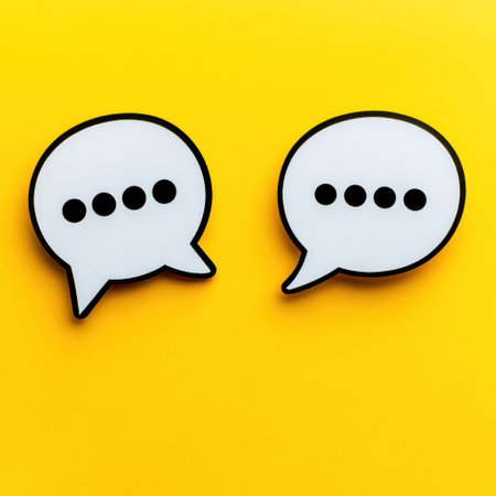 Two speech bubbles with ellipses on a bright yellow background symbolize communication and interaction.の素材