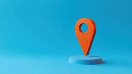 A vivid orange location pin stands on a light blue base, creating a striking visual against the solid blue background.の素材
