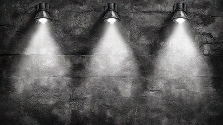 Bright spotlights cast soft beams on an industrial concrete wall, creating a moody atmosphere.の素材